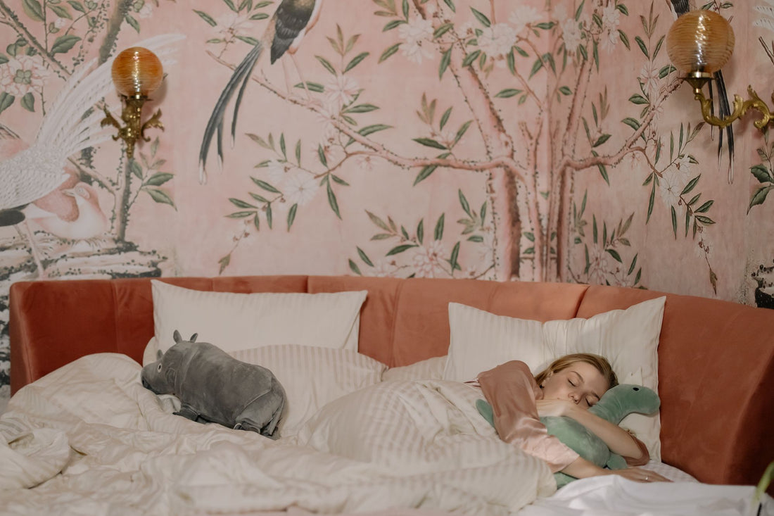 Woman napping in bed while hugging a soft plush toy