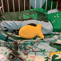 Goldfish cracker plush on a colorful children's bed